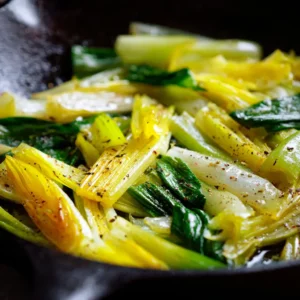Sautéed Leeks (The Perfect Buttery Side Dish) 4 A close-up view of buttery sautéed leeks in a pan, showing their tender texture and glossy sheen from the butter and olive oil.
