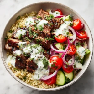 Mediterranean Steak Bowl Recipe (The Only One You'll Ever Need) 3 A close-up of the juicy, marinated steak being sliced against the grain for the Mediterranean bowl, highlighting its perfect medium-rare cook.