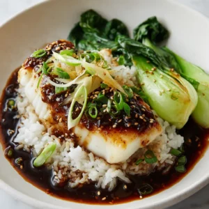 Ginger Soy Fish with a Glossy Umami Glaze and Steamed Bok Choy 3 Pan-seared flaky white fish fillet with a dark ginger soy glaze on a white plate. (Ginger Soy Fish)
