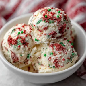 Christmas Cookie Ice Cream: The Ultimate Creamy Holiday Dessert Recipe 3 Three scoops of creamy off-white Christmas Cookie Ice Cream in a ceramic bowl, showing dense cookie inclusions. (Christmas Cookie Ice Cream)