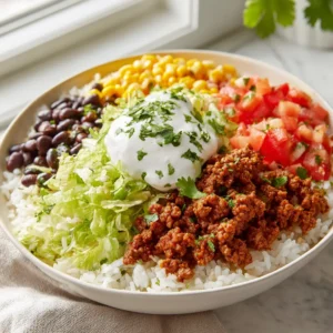 Ground Beef Taco Bowls: The Ultimate Weeknight Meal Prep Solution 3 Close up shot of Ground Beef Taco Bowls showing the reddish-brown spice glaze on the crumbled meat and vibrant vegetables.